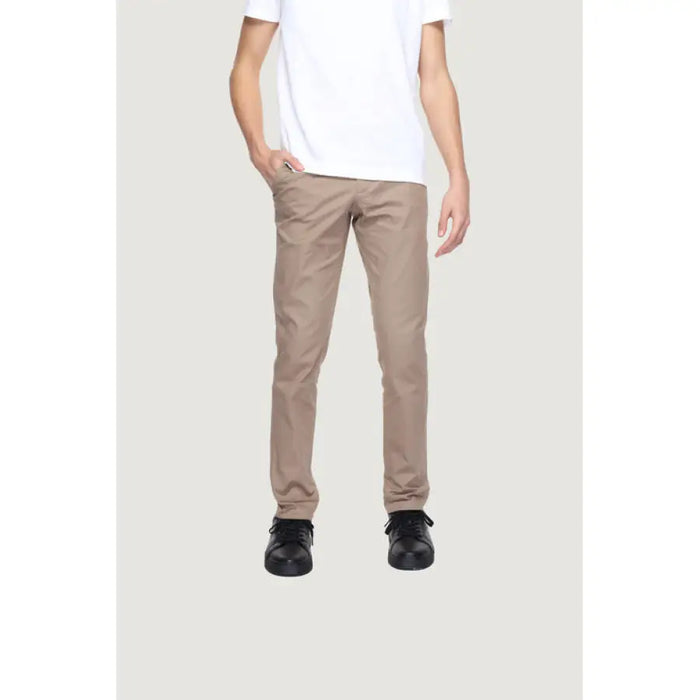 Man in white t-shirt and khaki trousers from Alviero Martini Prima Classe collection