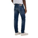 Man in white t-shirt and Replay Men Jeans showcasing urban city style fashion