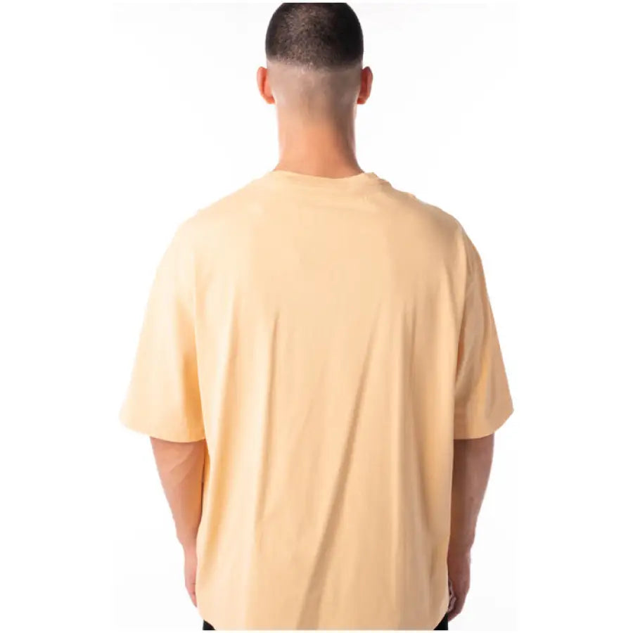 Urban style: Man wearing a yellow Jordan Men T-Shirt