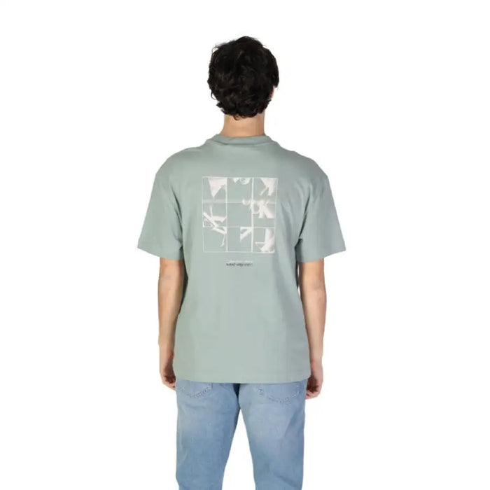 Mint green Calvin Klein Jeans t-shirt featuring a geometric design on the back