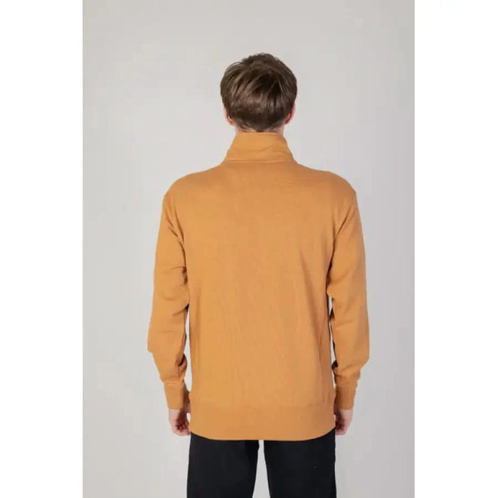 Mustard yellow turtleneck sweater from New Balance Men Sweatshirts viewed from behind