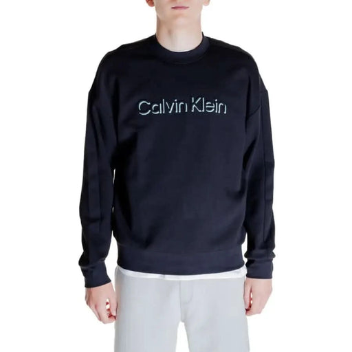 Navy blue Calvin Klein sweatshirt with light-colored logo text across the chest