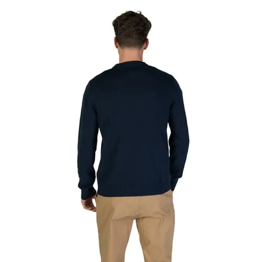 Navy blue crew neck sweater paired with khaki pants by Tommy Hilfiger