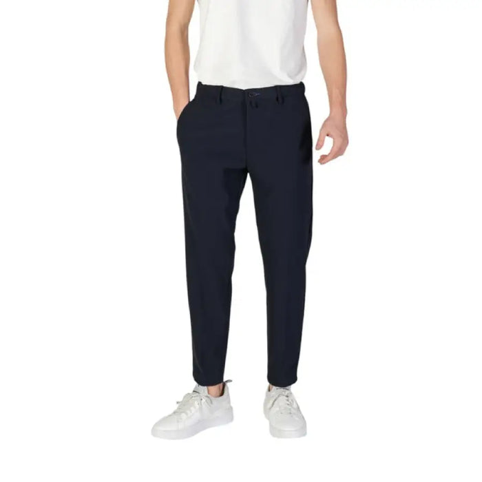 Navy blue tapered dress pants paired with white sneakers by Borghese Men Trousers