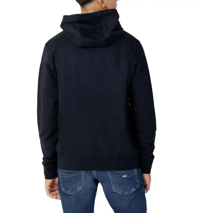 Navy blue hooded Armani Exchange sweatshirt worn by a person seen from behind