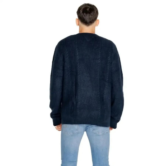 Navy blue knit sweater worn by person from behind in Tommy Hilfiger Men Knitwear