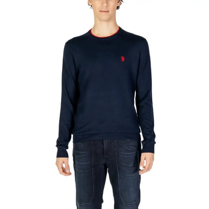 Navy blue U.S. Polo Assn. men’s premium knit sweater with red trim and logo