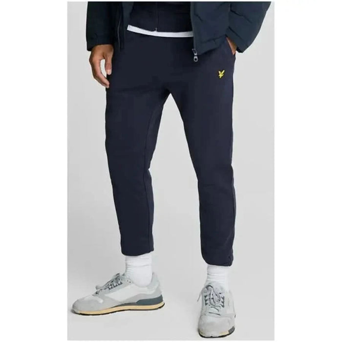 Navy blue Lyle & Scott men’s sweatpants with yellow logo on upper thigh