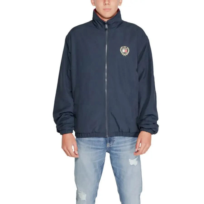 Navy blue zip-up jacket with circular logo patch by Tommy Hilfiger for men