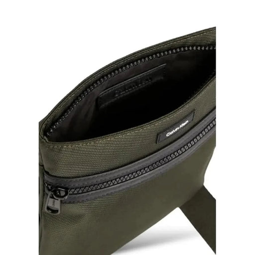 Olive green Calvin Klein crossbody bag featuring zipper compartments for men