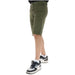 Olive green knee-length Lyle & Scott Men Shorts paired with black and white sneakers