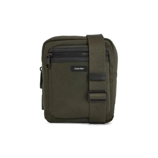 Olive green Calvin Klein messenger bag with adjustable strap and zippered compartments