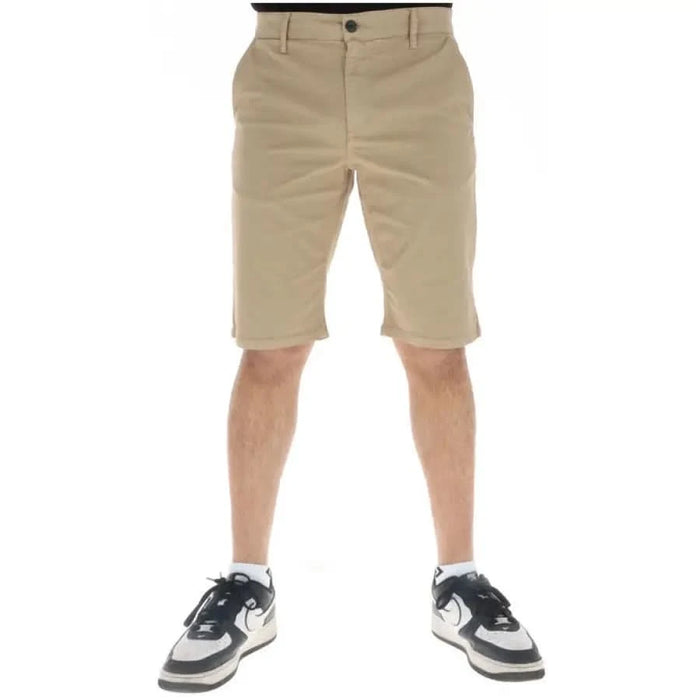 Pair of beige khaki shorts worn with sneakers from Lyle & Scott Men Shorts collection