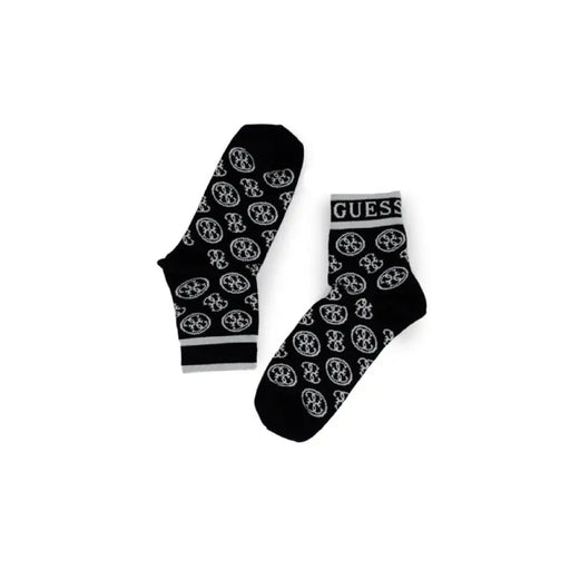 Pair of black socks featuring white circular logo pattern and GUESS branding