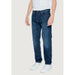 Pair of blue denim jeans worn by a person in a white shirt from Armani Exchange