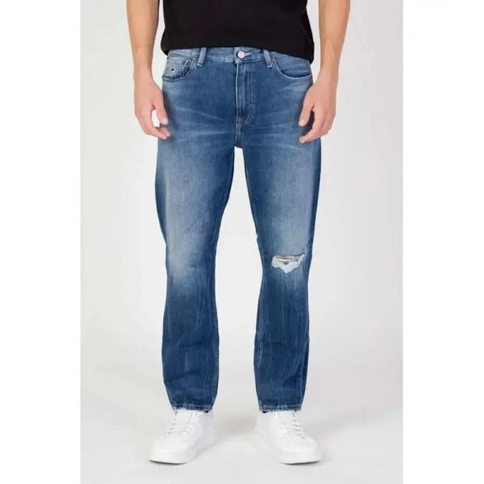 Blue Denim Tommy Hilfiger Jeans for Men featuring a distressed knee rip