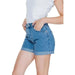 Blue denim shorts with rolled cuffs worn by a person in a white top - Vero Moda Women Short