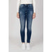 Pair of blue skinny jeans worn with a white sweater from Calvin Klein Jeans