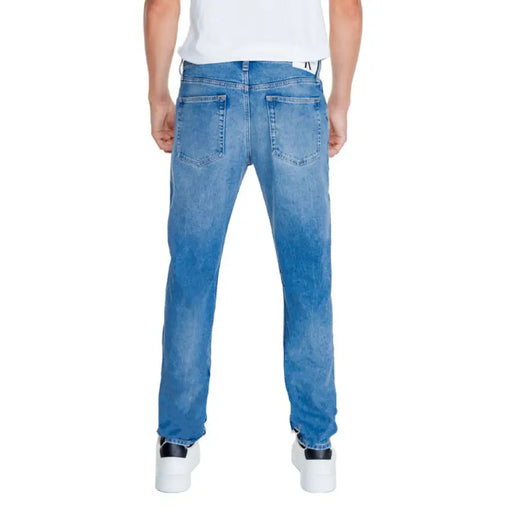 Light blue denim jeans displayed from the back by Calvin Klein Jeans for men