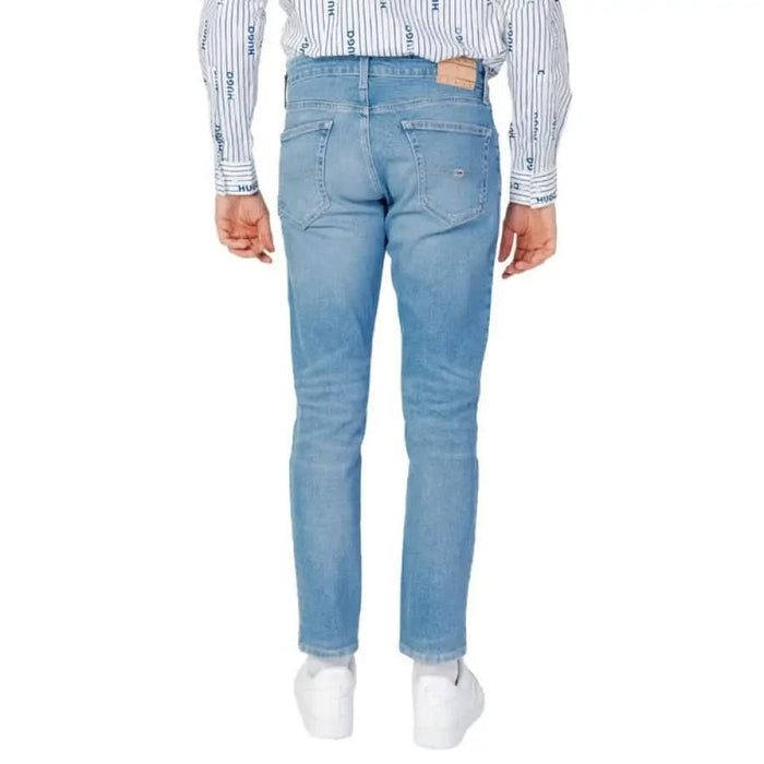 Light blue denim jeans from the back, featuring Tommy Hilfiger logo detailing