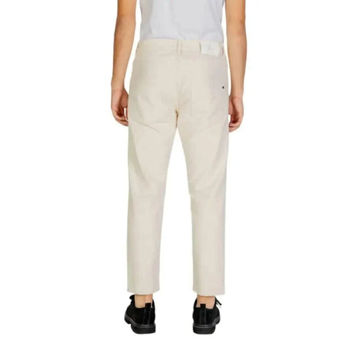 Pair of off-white Gianni Lupo men trousers viewed from the back, showcasing casual style