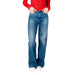 Wide-leg blue jeans styled with a red top and white shoes by Tommy Hilfiger