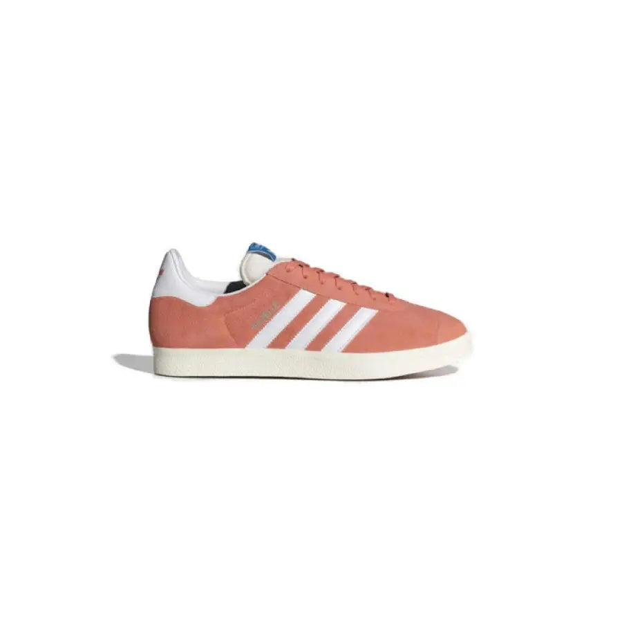 Peach-colored Adidas sneaker with white stripes and sole, available in Adidas Women Sneakers