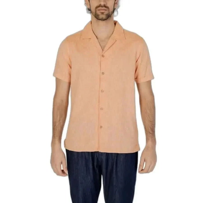 Peach short-sleeved button-up shirt for men by Hamaki-ho, paired with dark pants