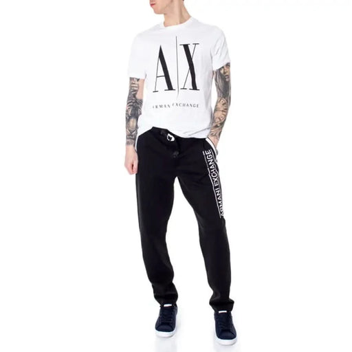 Person wearing Armani Exchange outfit with white AX logo t-shirt and black sweatpants