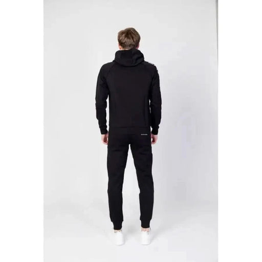 Person in a black hooded tracksuit from behind, featured in Ea7 Men Sweatshirts