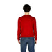 Person in bright red sweater and blue jeans showcasing U.S. Polo Assn. Men Knitwear