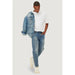 Person in distressed blue jeans, white t-shirt, and denim jacket for Only & Sons