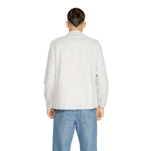 Back view of person wearing Antony Morato white long-sleeved shirt and blue jeans