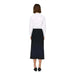 Person in a white long-sleeved top and black skirt from Jacqueline De Yong collection