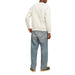 Person in a white sweater and blue jeans, showcasing Jack & Jones Men Sweatshirts design