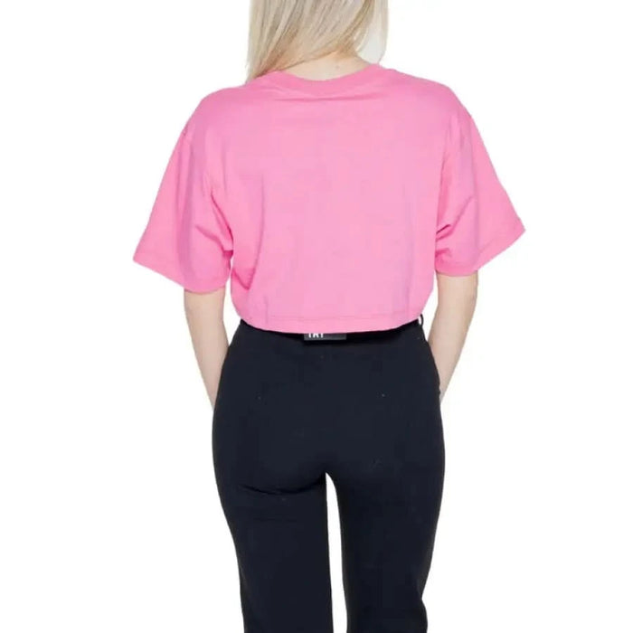 Pink cropped t-shirt worn with black leggings, view from the back - Pharmacy Women T-Shirt