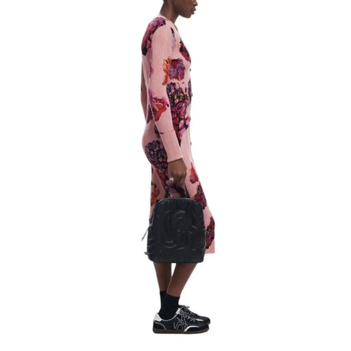 Pink floral dress with long sleeves modeled by a person beside Desigual Women Bag