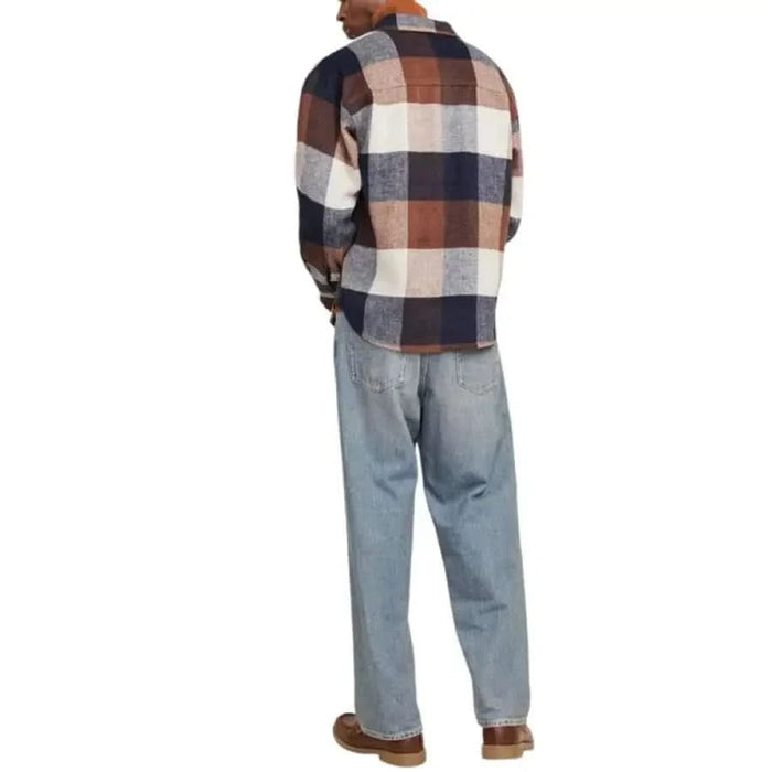 Plaid flannel Jack & Jones men shirt paired with light blue jeans viewed from behind