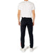 Rear view of a person in white shirt, black trousers with red stripes - Le Coq Sportif Men Trousers