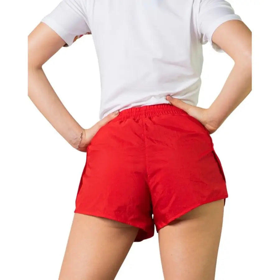 Adidas Women Short: Red athletic shorts paired with a white t-shirt