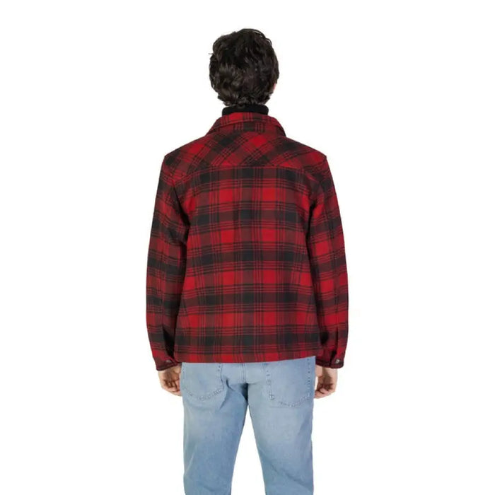 Red and black plaid flannel jacket paired with light blue jeans in Gas Men Shirt