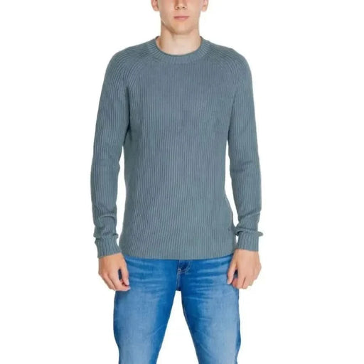 Ribbed blue-gray sweater on a model from Calvin Klein Jeans Men Knitwear collection