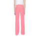 Silence Women wearing The Row pink crepy trousers for urban city style fashion