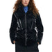 Shiny black Desigual women’s puffer jacket with front zipper worn by a curly-haired person