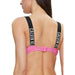 Calvin Klein sports bra with black straps and pink band featuring CALVIN KL text