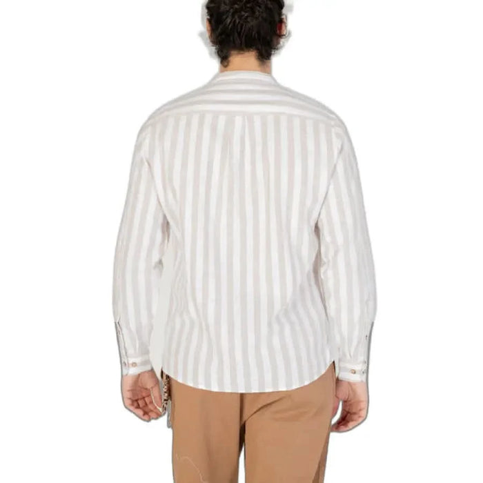 A model wearing a Hamaki-ho striped white button-down shirt, viewed from the back