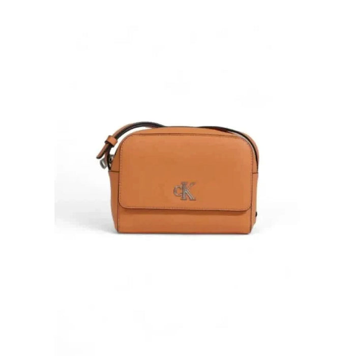 Tan leather crossbody bag by Calvin Klein featuring a small logo on the front