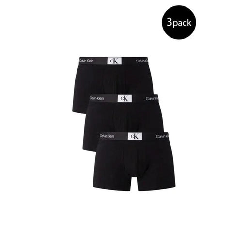 Three black Calvin Klein boxer briefs with elastic waistbands and CK logo