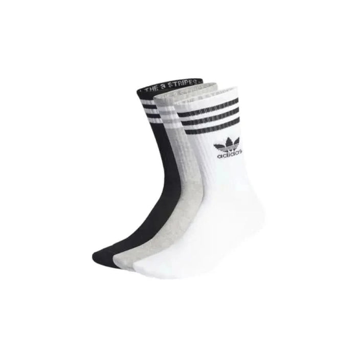 Three pairs of black and white Adidas crew socks with striped cuffs and trefoil logo