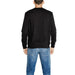 Back view of a person wearing an Antony Morato black sweater and blue jeans